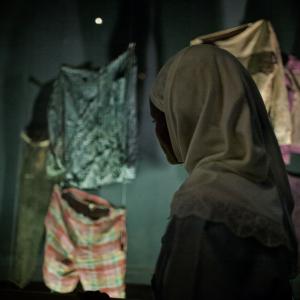 A student gazes on genocide victim's clothing A student gazes on genocide victim's clothing